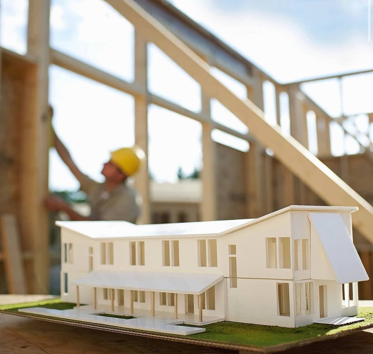 Architectural model of a building on a construction site desk