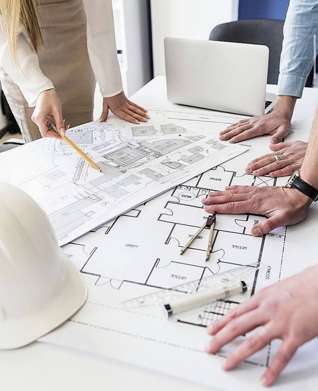 Engineers reviewing building plans and blueprints