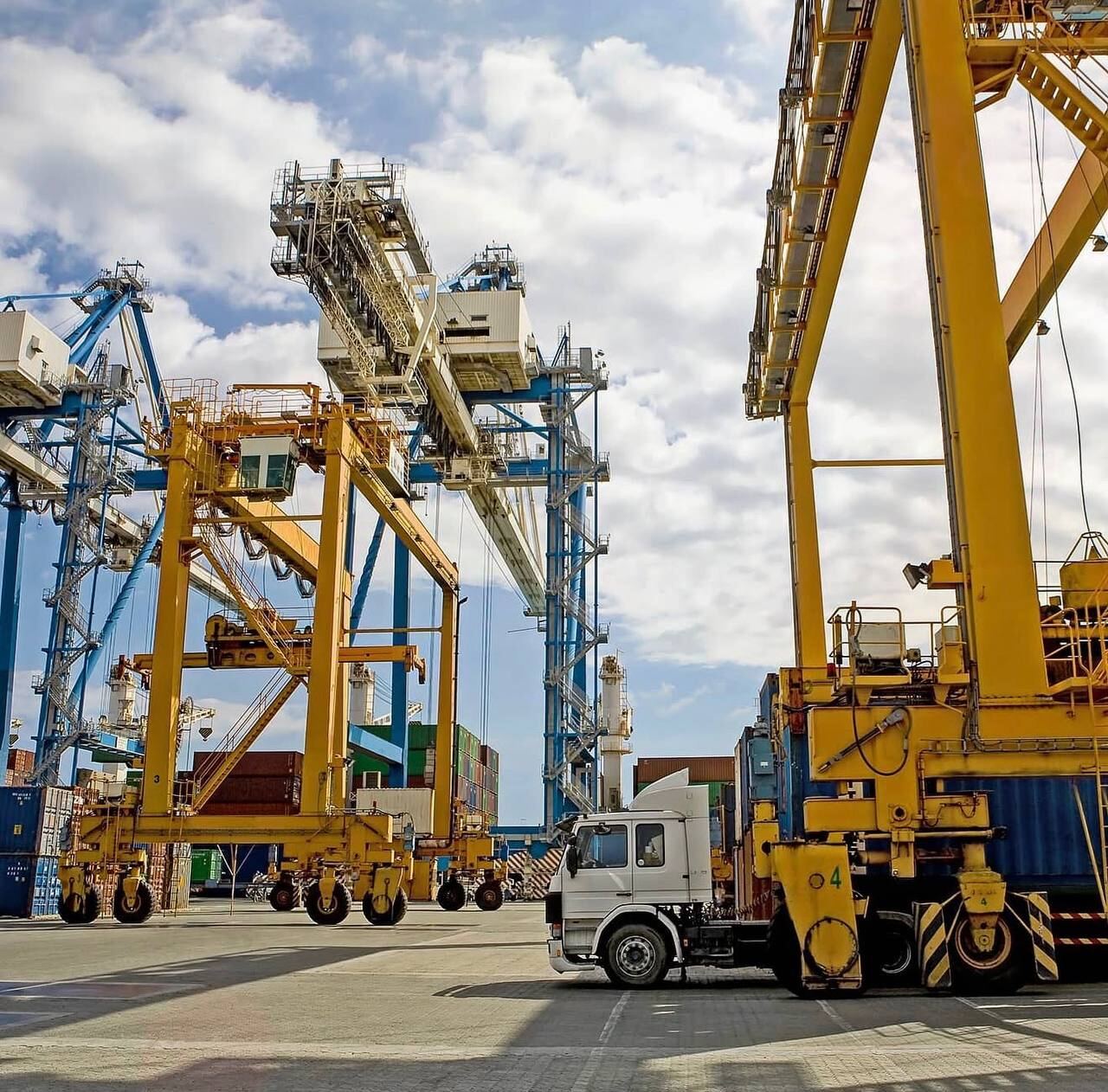 Large gantry cranes and heavy equipment at a port facility