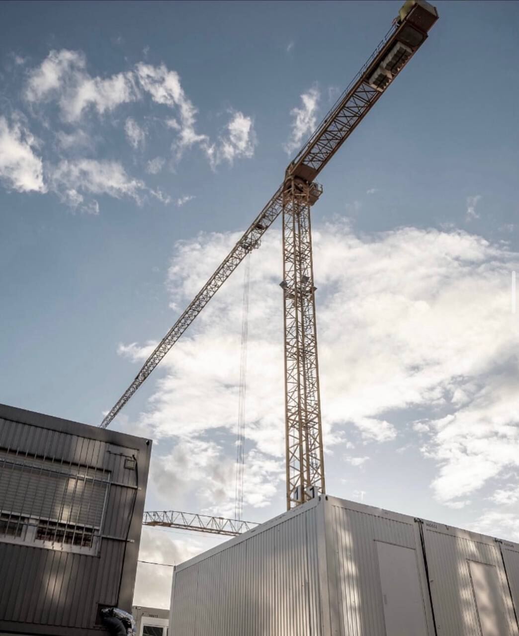 Tower crane against a dramatic evening sky